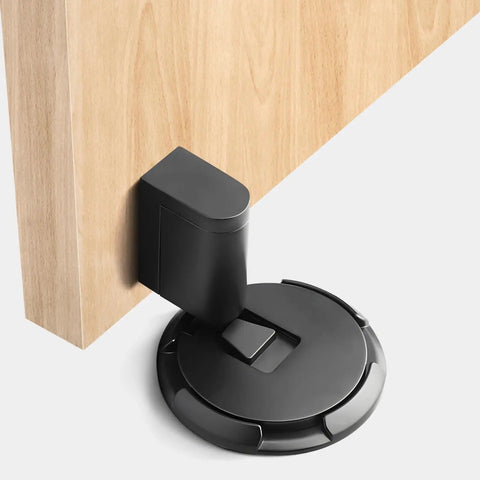 Floor Mount Door Stopper With Spring Loaded Mechanism, Zinc Alloy Build, Hidden Flush Design, attached to a wooden door.