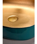 Heavy Duty Rectangular Vessel Sink Installed Above Counter From Porcelain Ceramic With A Sleek Closed Glaze, close-up of gold drain hole.