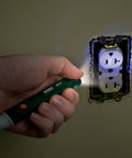 Extech MD10 non-contact magnet detector flashlight, green pocket-sized tool, blue LED indicator near wall outlet