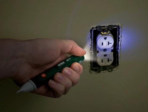 Extech MD10 non-contact magnet detector flashlight, green pocket-sized tool, blue LED indicator near wall outlet