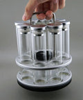 Eight Single Dose Espresso Bean Storage Tubes With Rotating Display Rack And Precision Funnel Set held by hand, clear glass, stylish design, airtight.