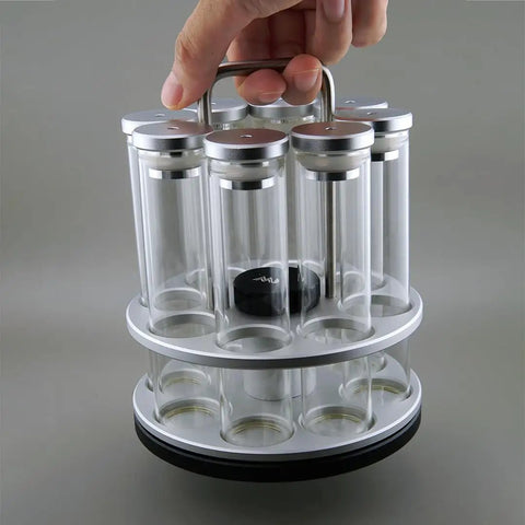 Eight Single Dose Espresso Bean Storage Tubes With Rotating Display Rack And Precision Funnel Set held by hand, clear glass, stylish design, airtight.