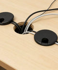 Premium Desktop Grommet Covers Slick Cable Organizers Hella Tough ABS Plastic Wire Routing Kit For Working From Home Office Setup No Mess Cord Management 5 Pack Black Two Point Five Inch Opening Sweet Fit Design on a wooden desk hiding cables.