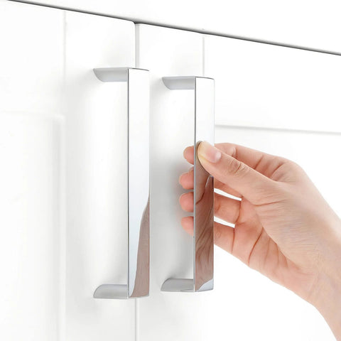 10 Pack 5 Inch Polished Chrome Cabinet Pulls being installed on a white kitchen cabinet door with 128mm hole centers