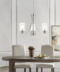 Three-Light Brushed Nickel Chandelier With Clear Glass Shades, Modern Farmhouse Pendant Lighting over dining table