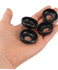 Hand holding four black rings from Mountain Bike Rear Axle Steel Washer Kit For Hub Maintenance And Repair Built To Last, Tough As Nails Safety Washers