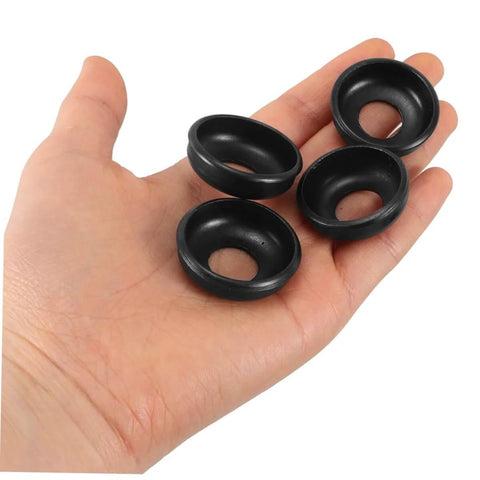 Hand holding four black rings from Mountain Bike Rear Axle Steel Washer Kit For Hub Maintenance And Repair Built To Last, Tough As Nails Safety Washers