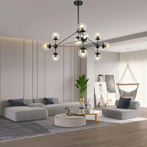 10 Light Modern Black Sputnik Chandelier With Clear Globe Shades in a stylish living room with grey sofas and a hammock chair.