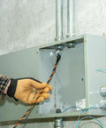 High Flex 75 Foot Tri Strand Polyester Fish Tape For Smooth Electrical Wire Pulling being fed through a conduit box.