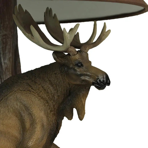 Close-up of moose detail on rustic resin base of Wildlife Moose Table Lamp With A 12 Inch Forest Print Lampshade For Living Rooms Cabins And Bedrooms Delivers Cozy Warm Glow And Striking Rustic Decor Standing 20 Inches Tall For A Commanding Home Accent.