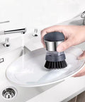 Stainless Steel Dish Scrubber With Built In Soap Dispenser used to clean plate in kitchen sink