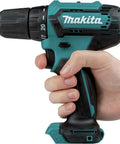 Person holding Compact 12V Max Cordless Driver Drill With Three Eighths Inch Chuck, dual speed, rubberized soft grip handle.