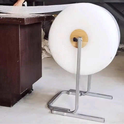 Floorstanding Bubble Wrap Roll Dispenser Heavy Duty Vertical Packaging Stand 59 Inches tall holding bubble wrap roll on a smooth floor.