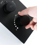 User adjusting the control knob of the Premium Matte Black Shower System With Waterfall Rain Head And Handheld Spray Set.