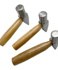 Three heavy duty flat faced hammers for jewelry making and metalworking with wooden handles and metal heads, for silversmithing.
