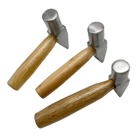 Three heavy duty flat faced hammers for jewelry making and metalworking with wooden handles and metal heads, for silversmithing.