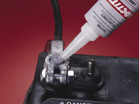 Applying dielectric tune-up grease for electrical connections to a battery terminal, creating a moisture-proof barrier against corrosion.