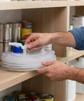 Collapsible Water Jug With Spigot For On The Go Camping And Hiking Clear Foldable Water Carrier being placed on a shelf