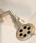 Anystream 360 Showerhead With Three Spray Settings, Consistent 2.5 GPM Flow in Brushed Nickel, wall-mounted view.