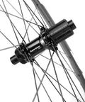 Close-up of hub and spokes on high-performance 50mm carbon fiber disc brake wheelset for road bikes, 700c clincher with UD matte finish.