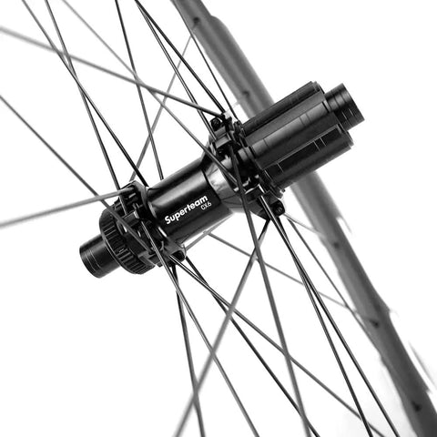 Close-up of hub and spokes on high-performance 50mm carbon fiber disc brake wheelset for road bikes, 700c clincher with UD matte finish.