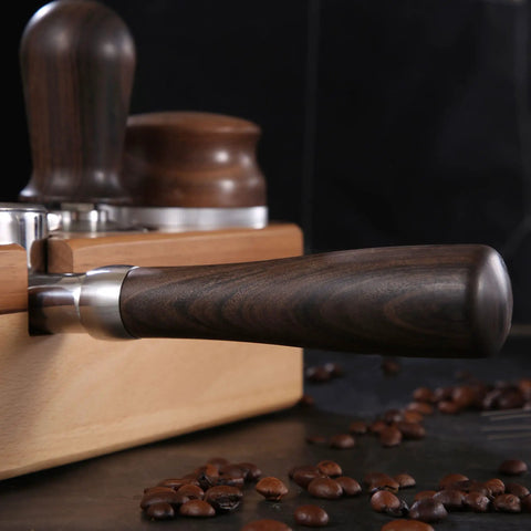 Close-up of the smooth wood ergonomic handle of a 58mm Bottomless Portafilter Featuring Smooth Wood Ergonomic Handle And Double Shot Filter Basket For Breville Oracle Espresso Machines Real Deal Barista Rig.