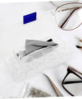 Open glasses repair kit with screws, nose pads, and precision screwdriver tools for quick eyeglass fixes at home.