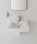 Modern white bathroom sink with wall-mounted mirror and soap dispenser