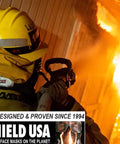 Firefighter using HS-2 Heat Shield For Face And Neck Burn Protection For Wildland Firefighters near intense flames.