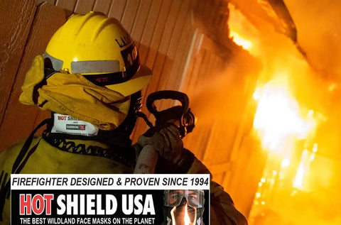 Firefighter using HS-2 Heat Shield For Face And Neck Burn Protection For Wildland Firefighters near intense flames.