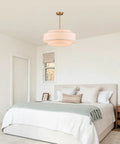 Totally Iconic 24 Inch Linen Drum Chandelier With Six Warm Lights Featuring Sleek Gold Frame And Three Tier Vintage Farmhouse Design in a bedroom