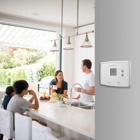 Family dining with view of Digital Non Programmable Thermostat With Clear Digital Display And Soft Touch Buttons in kitchen