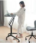 Smooth Rolling Mobile Standing Desk With Pneumatic Height Adjustable Laptop Cart super slick lift system used by a woman, stylish home office setup.