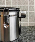Rock Solid 304 Stainless Steel Coffee Canister Featuring One Way Degassing Valve And Rotatable Date Tracker Keeps Your Daily Grind Fresh And Legit Snap Tight Airtight Tea Storage Container on kitchen counter.