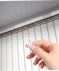 Hand holding clear hook showing 40 Pack Plastic Curtain Hooks For Doors And Curtain Rods With Silent Glide No Fuss Easy Hanging For Home And Bathroom
