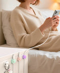8 Pack Cable Clips Cord Organizer With One Hand Lock And Extra Strong Adhesive, used on a nightstand to hold phone charging cable.