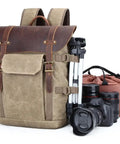 Canvas DSLR Video Backpack With Waterproof Outdoor Design, Shock Resistant Shell, cameras, lenses, tripod, and gear on display