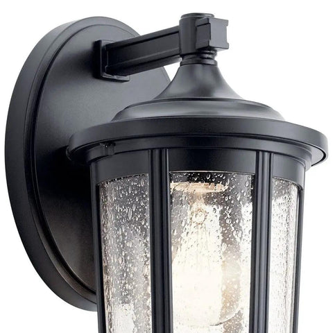 Close-up of Fairfield 11 Inch Outdoor Wall Light 1 Light Black Finish With Clear Seeded Glass Downward Lighting, mounted on wall.