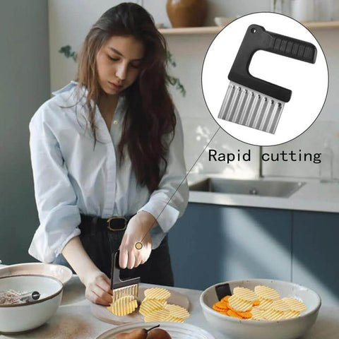 Front view of a crinkle-cut veggie knife with black handle and stainless-steel wavy blade, used for slicing potatoes and carrots.