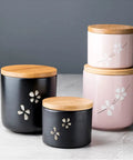 Matte Black Ceramic Coffee Canister With Premium Airtight Seal Keeps Your Daily Grind Fresh No Fuss Wide Mouth Design For Easy Scooping And Reliable Kitchen Pantry Storage, shown in a floral design.