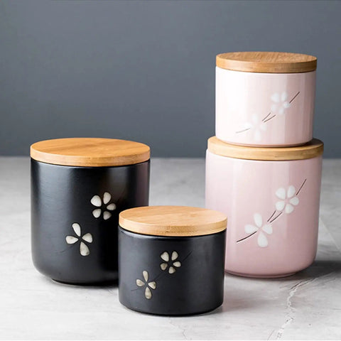 Matte Black Ceramic Coffee Canister With Premium Airtight Seal Keeps Your Daily Grind Fresh No Fuss Wide Mouth Design For Easy Scooping And Reliable Kitchen Pantry Storage, shown in a floral design.