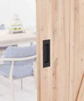 6 1/2 Inch Matte Black Frosted Flush Pull For Sliding Barn Doors installed on wooden door