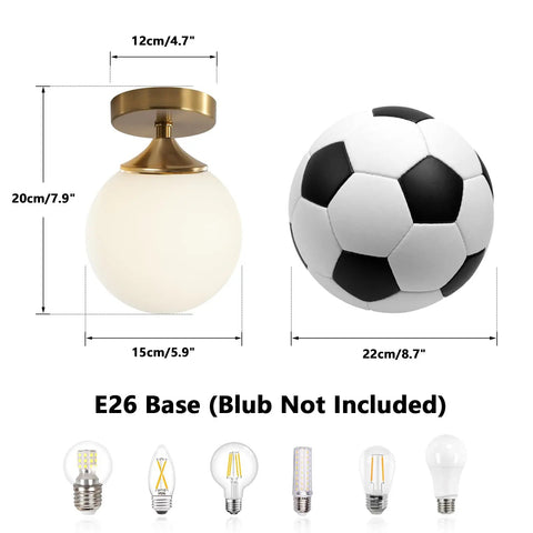 Milk Glass Globe Semi Flush Mount Ceiling Light With Gold Brass Finish Mid Century Modern Style For Hallway Entryway And Bedroom Retro Vibe Brass Ceiling Fixture With Elegant Glass Shade And Contemporary Charm next to a soccer ball for size comparison, E26 base shown without bulb