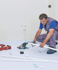 Worker on Temporary Floor Protection Roll 36 Inch By 100 Foot Anti Slip Surface Easy To Apply Paint Proof Reusable Material