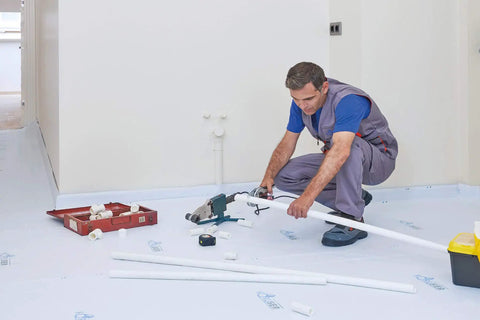 Worker on Temporary Floor Protection Roll 36 Inch By 100 Foot Anti Slip Surface Easy To Apply Paint Proof Reusable Material