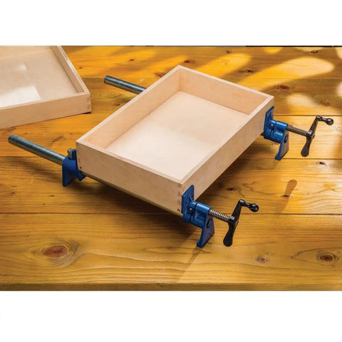 Beefy Extra Wide 3/4 Inch Pipe Clamps For Woodworking with 2-1/2 Inch Jaws securing wooden frame on a workbench