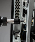 Close-up of knurled security screwdriver bit engaged with a tamper-proof screw in a server chassis.
