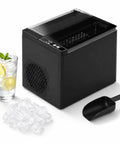 Portable Countertop Ice Maker Slings Nine Swift Bullet Cubes In Six Minutes And Cranks Out Twenty Six Pounds Daily With Silent Running and a glass of iced drink.