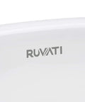 Close-up of logo on undermount white oval ceramic bathroom sink with overflow rear drain, designed for durable and seamless installation.