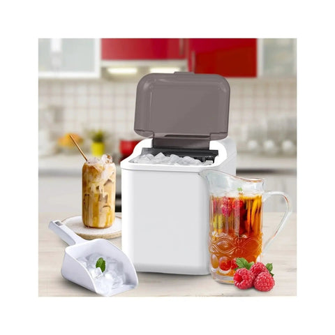 Fast Countertop Ice Maker Portable With Self Cleaning Setup Produces Crisp Cubes In Minutes And Delivers Twenty Six Point Five Pounds Daily is in a kitchen with ice scoop.